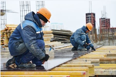 two men winterizing their construction job site.